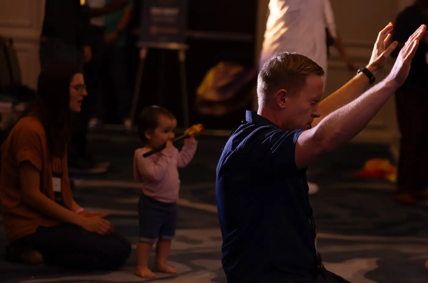 A father and child worshipping together during a session
