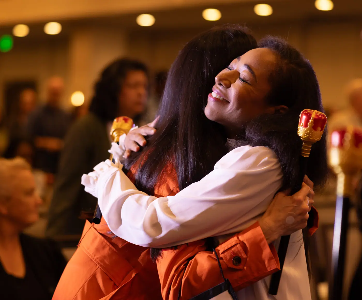 Two attendees embracing after a ministry session