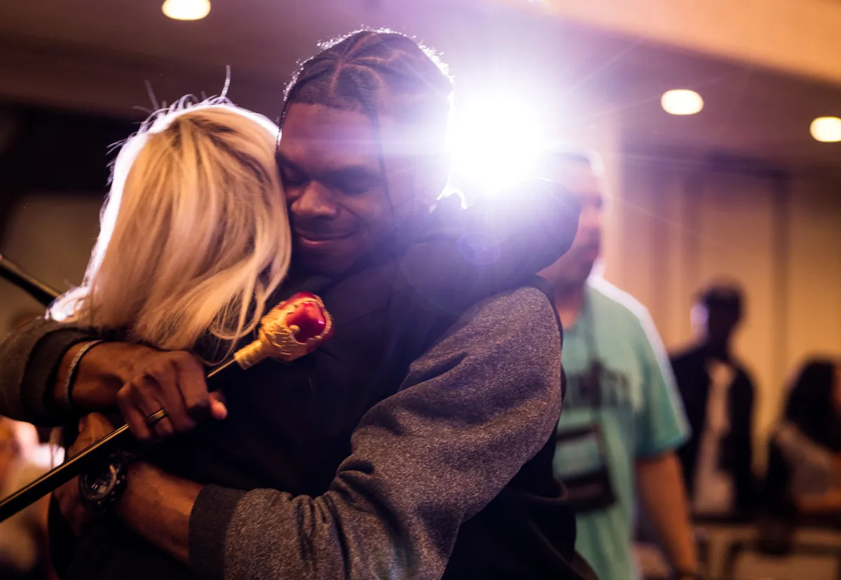 Two attendees embracing during a ministry time at a past Bride Tribe Advance