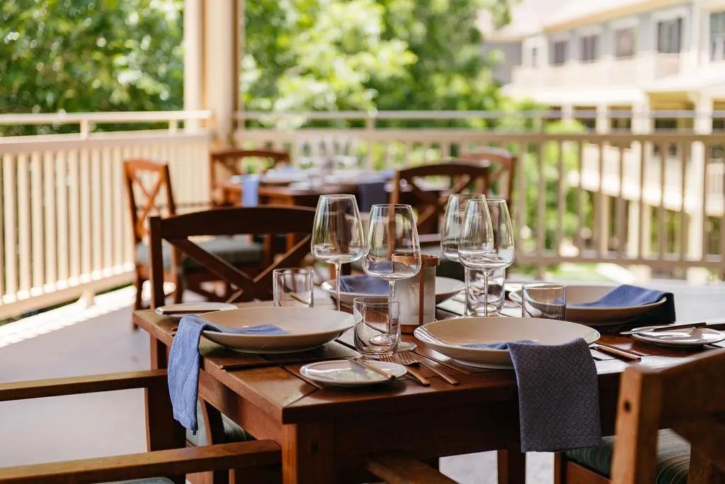 A table set for dinner on a covered porch