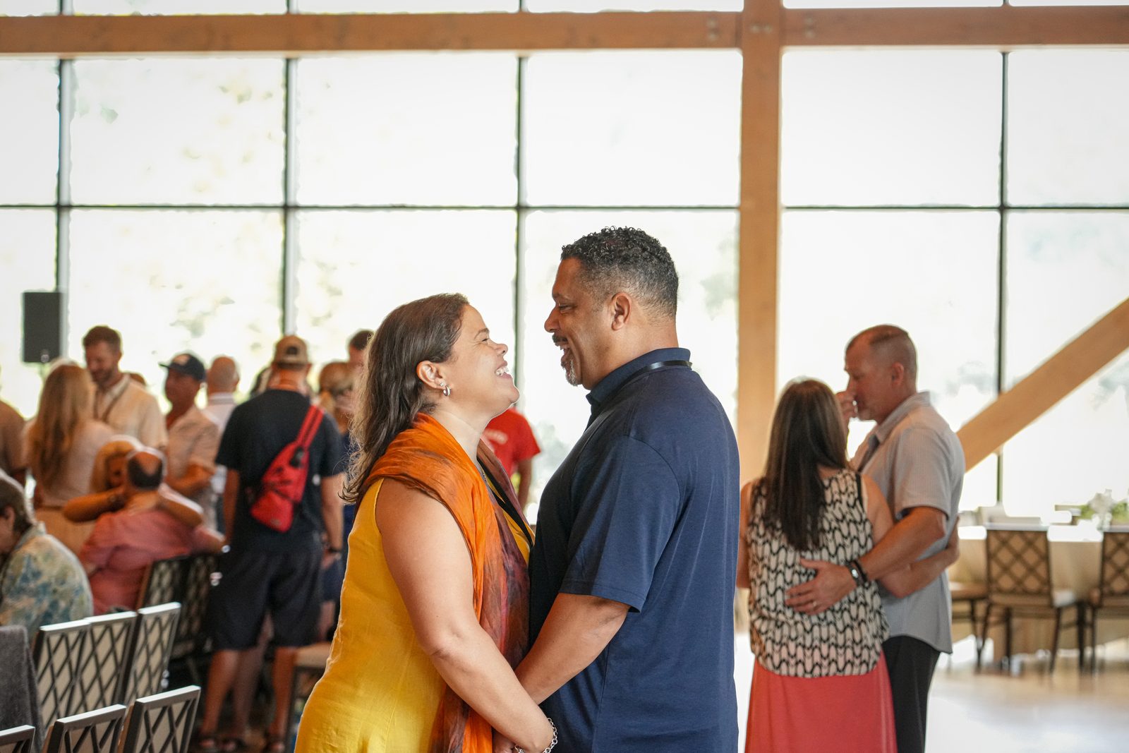 A couple embracing in a bright room with tall windows at the 2026 Advance